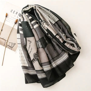 Detail of artistic cotton-linen scarf with geometric horse carriage prints and soft texture