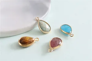 Detailed view of faceted teardrop natural gemstone pendants with gold-plated metal edges