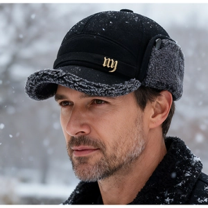 Detailed close-up of winter wool baseball cap with earflaps and grey faux fur lining