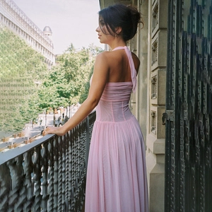 Detail showing pink halter neck V-neck evening dress with elegant pleated mesh fabric