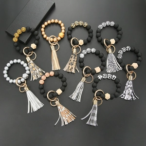 Silicone bead keychain bracelets with wooden bead and tassel charms in multiple colors