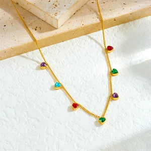 Detail of a gold choker chain featuring vibrant heart-shaped colorful gemstones