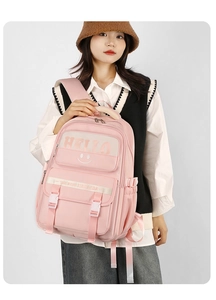 Pink school backpack detail showing secure dual buckle closures and multiple storage pockets