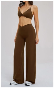 Detail of high-waist V-shaped crossover waistband on dark brown wide-leg yoga pants