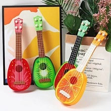Detailed close-up of four fruit-themed plastic ukulele toys in various bright colors