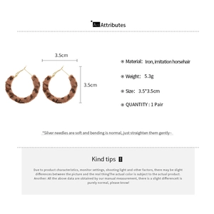 Detail of leopard print pony hair earrings showing 3.5cm diameter and 5.3g weight