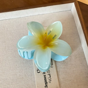 Detail of blue gradient lily flower hair claw clip with translucent resin texture
