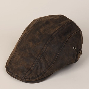 Detail view of the vintage newsboy cap with side metal vents and adjustable strap buckle