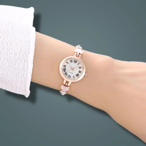 Elegant rose gold heart bracelet watch with crystals and Roman numeral dial on wrist