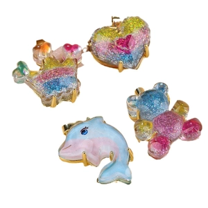 Sparkly resin cartoon charms with gold metal frames in dolphin, crown, bear and heart shapes