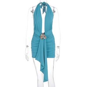 Détail d'une robe dos nu bleue avec boucle fleur en métal et plis sur la taille
