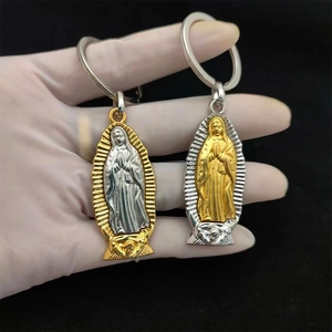 Detail of two-tone metal Virgin of Guadalupe keychains in gold and silver finish