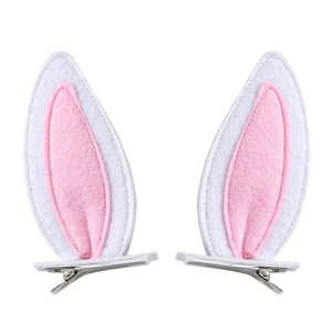 Close-up of pink and white plush rabbit ear hair clips with metal duckbill base