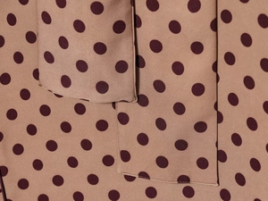 Close-up of polka dot fabric detail showing fine stitching and high-quality textile texture