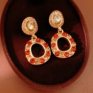 Vintage gold-plated hollow round earrings with amber rhinestones and crystal studs