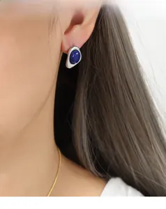 Close-up of silver irregular liquid metal stud earring with deep blue natural stone