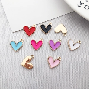 Close-up of assorted colorful enamel heart pendants with gold-plated metal alloy loops
