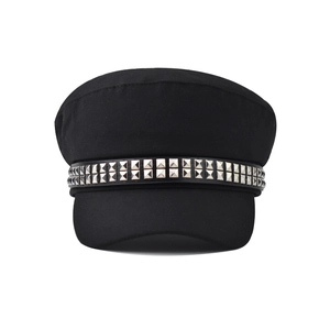 Detail of silver square studs on the black military style cap with punk aesthetic
