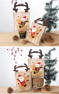 Detail of Christmas gift bag with Santa and snowman appliques and plush reindeer antlers