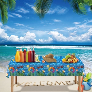 Detail of beach themed tablecloth featuring colorful swim rings and palm leaf patterns
