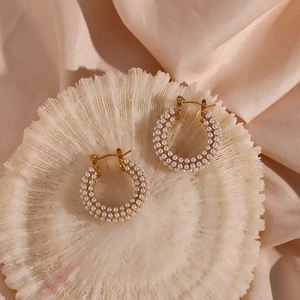 Macro view of 18K gold plated hoop earrings featuring intricate white pearl inlay