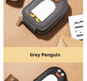 Close-up of cute penguin coin purse with lychee grain texture and gold zipper details