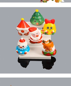 Set of 6 Christmas squishy toys including Santa, elk, and tree on a display stand