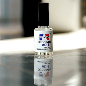 Detailed close-up of 10ml Evo Bond Debonder AD-1 liquid bottle for nail glue removal