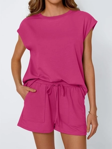 Detail of loose fit dark pink summer set showing crewneck top and drawstring shorts