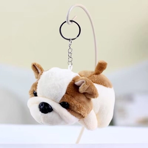 Close-up of brown and white puppy plush keychain with sturdy metal ring and chain