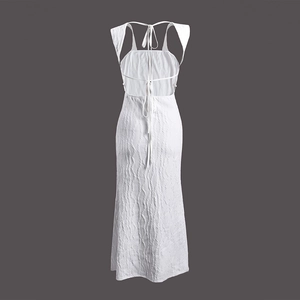 Detail of white striped backless maxi dress with delicate cross strap design and ripple texture