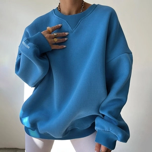 Detail of royal blue oversized sweatshirt with V-stitch neckline and sleeve embroidery