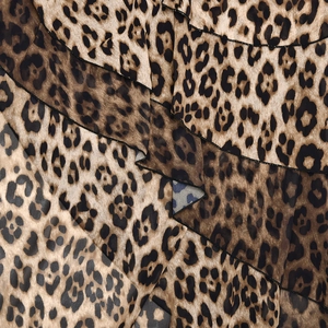 Macro view of layered ruffle design and detailed leopard print on chiffon fabric