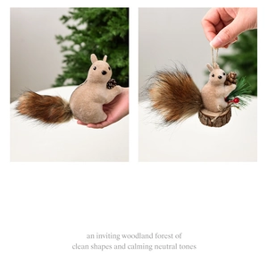 Detail of a brown fuzzy squirrel ornament holding a pinecone for Christmas tree decoration