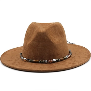 Close-up of brown suede cowboy hat with decorative beaded band and silver accents