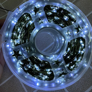 Waterproof cold white LED copper wire fairy lights on a star-shaped transparent spool