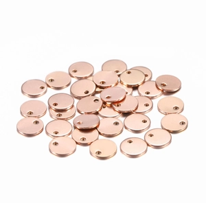 Macro view of several round rose gold stainless steel pendants for DIY jewelry making