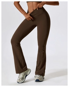 Close-up of high-waisted flared yoga pants with stylish crossover waistband detail