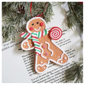 Close-up of resin gingerbread man ornament with sugar texture on vintage book background