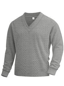 Detail of grey V-neck knit sweater showing jacquard texture and 90% cotton material label