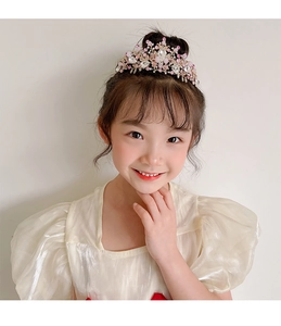 Detailed view of pink crystal girl crown headband on model for birthday parties