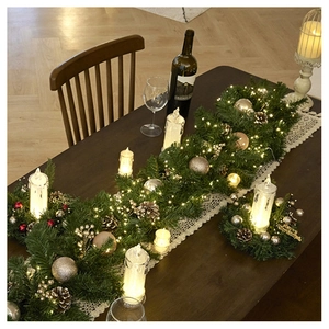 Christmas garland table runner with LED lights, golden baubles and pine cones decor