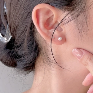 Elegant 925 sterling silver flower stud earrings with a white pearl center on model