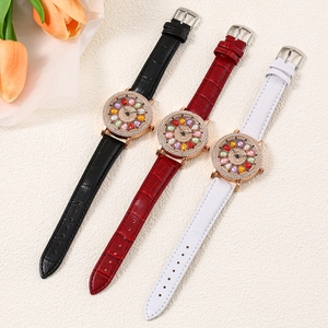 Close-up of luxury women's quartz watches with rhinestone bezels and leather straps