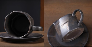 Macro view of Japanese vintage ceramic coffee cup with rustic black gold glaze texture