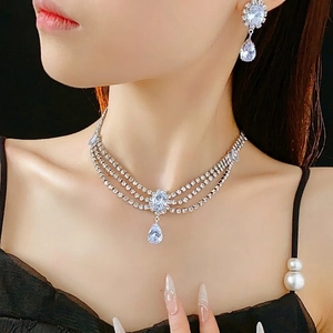 Luxury silver teardrop jewelry set with zircon necklace and earrings on a model