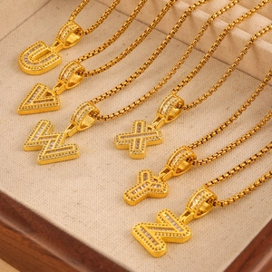 Golden box chain necklaces with zircon-studded alphabet pendants U to Z on a tray