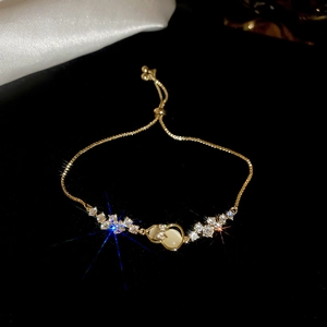 Detail of gold-plated bracelet with opal stones and sparkling cubic zirconia stones