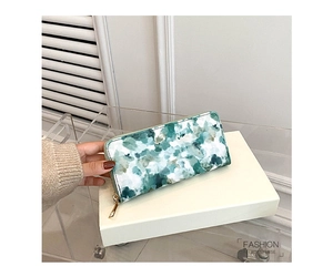 Close-up of elegant long marble pattern wallet with premium gold zipper and leather texture