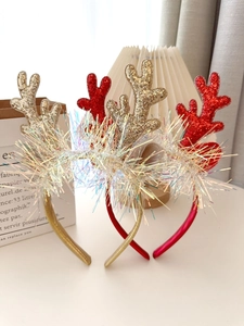 Close-up of Christmas reindeer antler headband with glitter sequins and holographic tinsel
